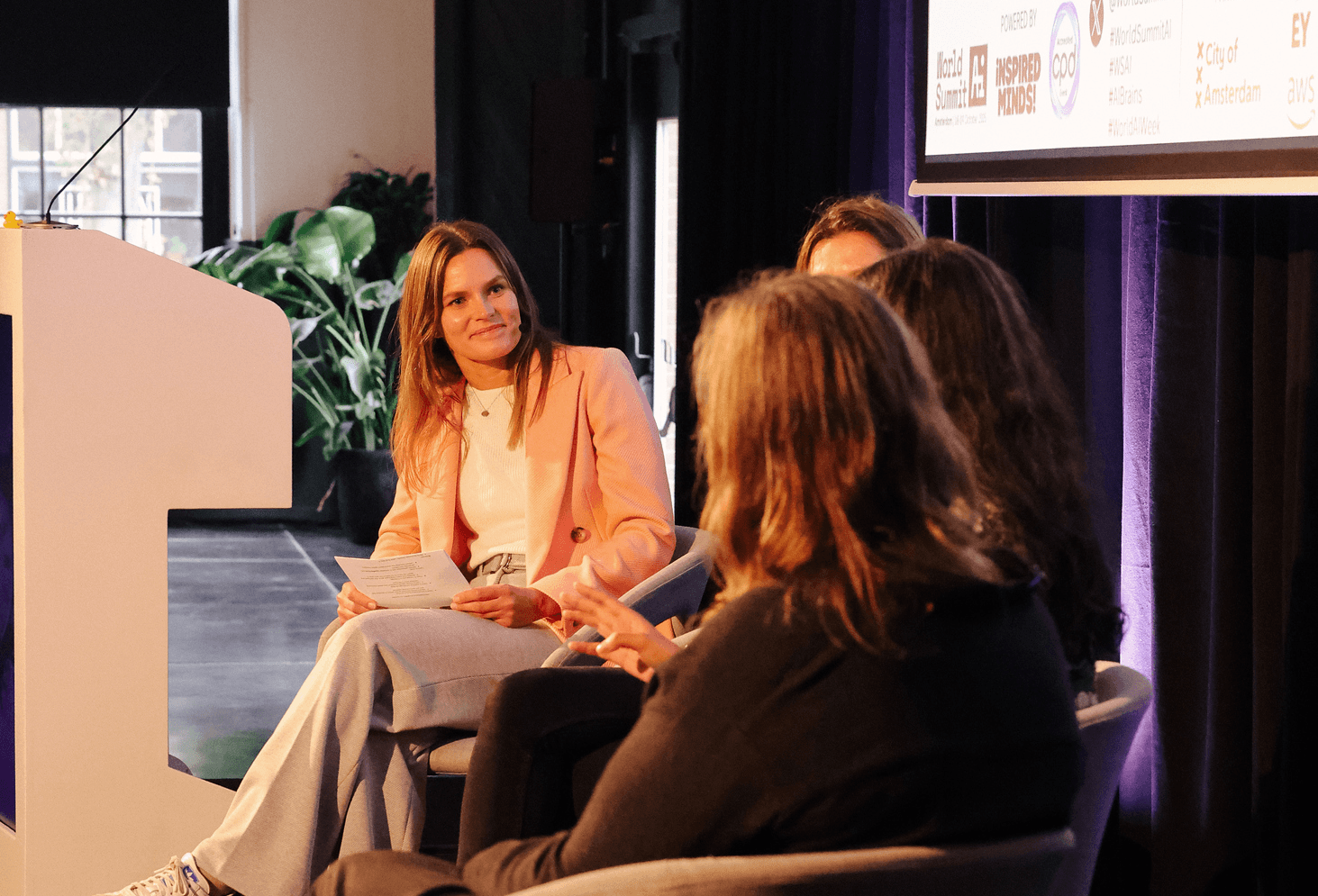 Marta Strykowska presenting to a seated audience at a speaking engagement
