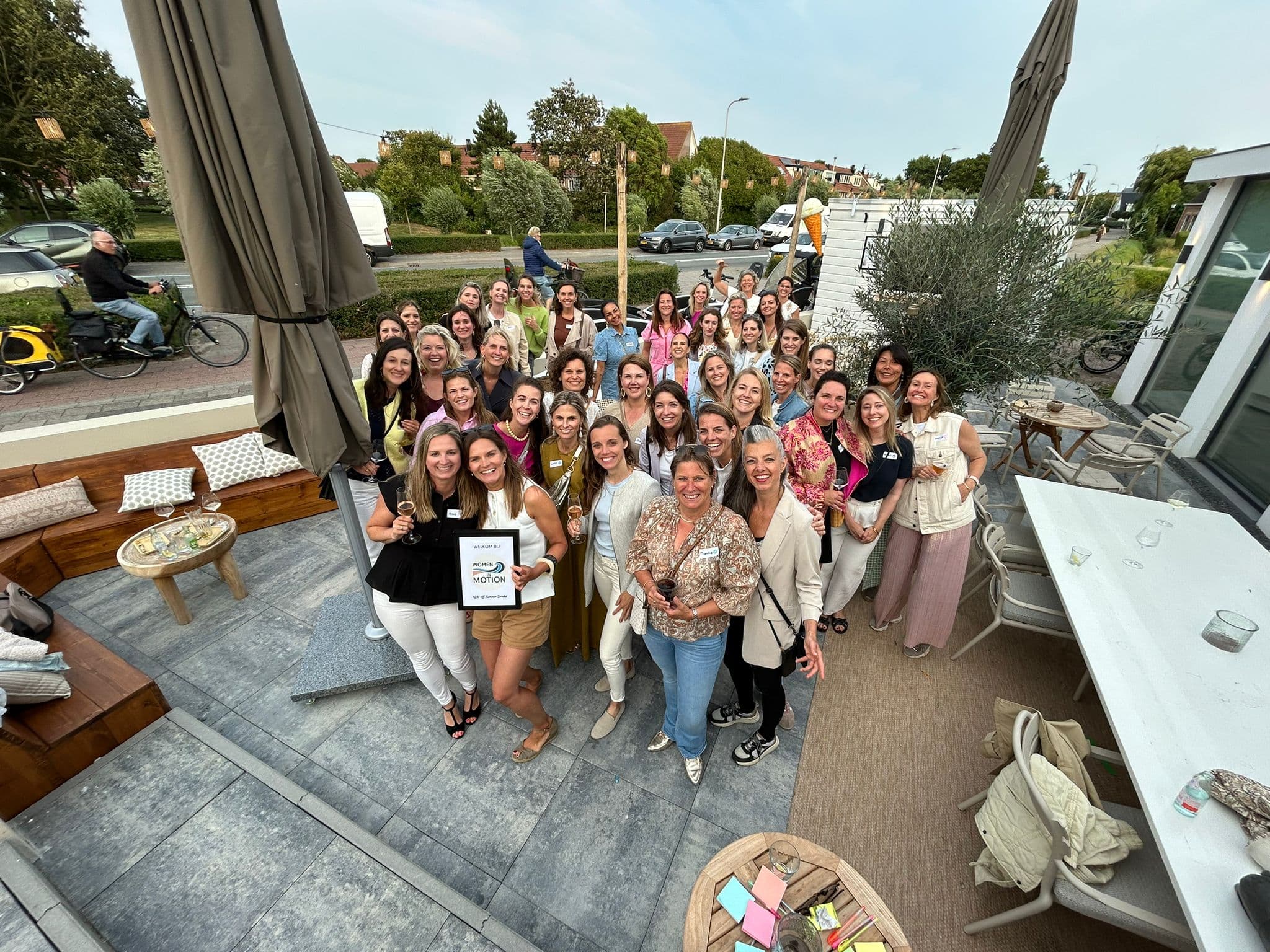 Aerial view of Women in Motion members gathered on a terrace at a Noordwijk networking event